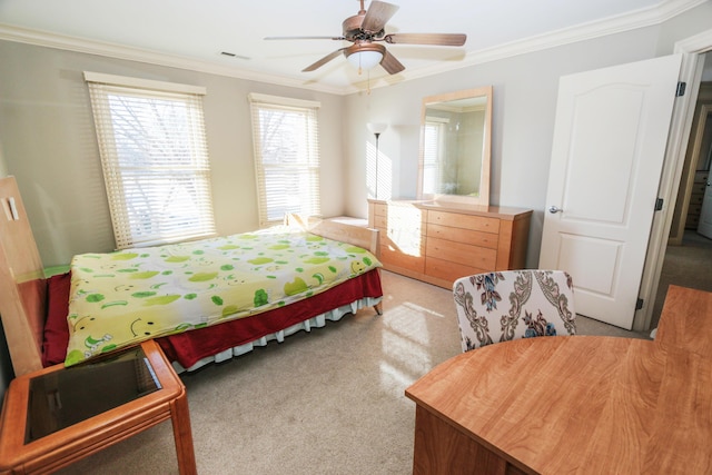 carpeted bedroom with ceiling fan and ornamental molding