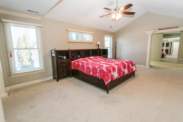 bedroom featuring ceiling fan, vaulted ceiling, carpet floors, and ornate columns