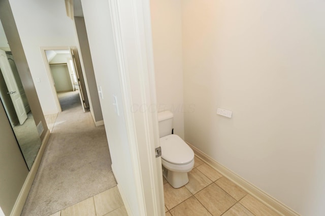 bathroom featuring toilet and tile patterned flooring