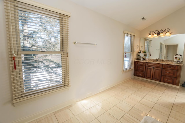 bathroom featuring tile patterned floors, vanity, and lofted ceiling