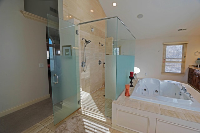 bathroom featuring plus walk in shower, tile patterned floors, and vanity