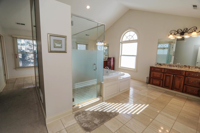 bathroom featuring plus walk in shower, vanity, lofted ceiling, and tile patterned flooring