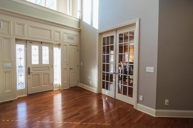 entrance foyer featuring a high ceiling, a wealth of natural light, and french doors