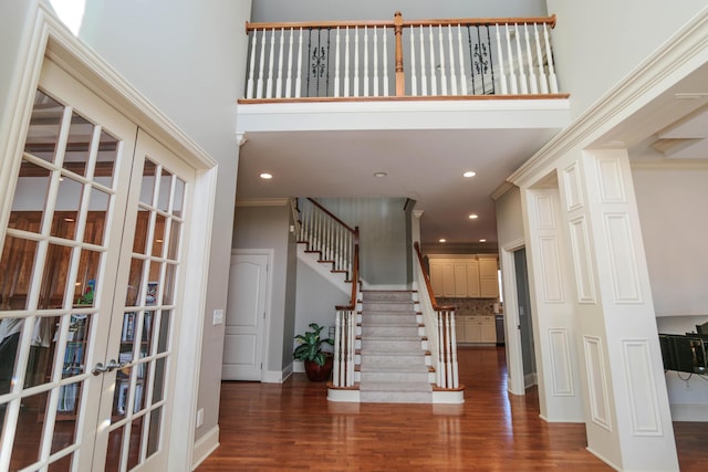 entryway featuring dark hardwood / wood-style floors, ornamental molding, and french doors