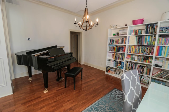 miscellaneous room featuring an inviting chandelier, dark hardwood / wood-style flooring, and crown molding