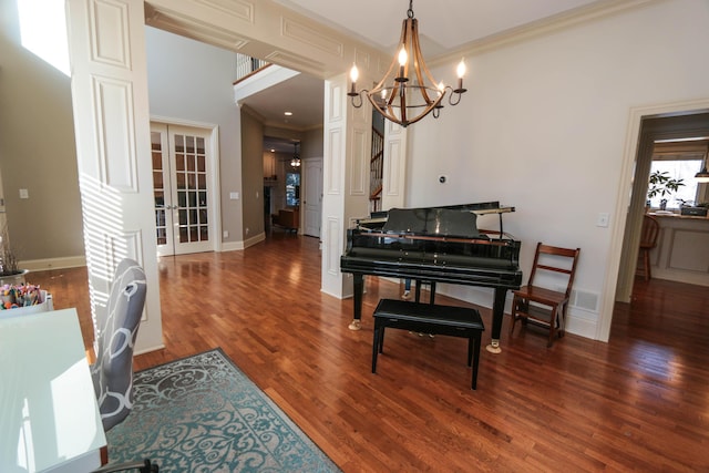 misc room with french doors, dark hardwood / wood-style floors, ornamental molding, and a chandelier