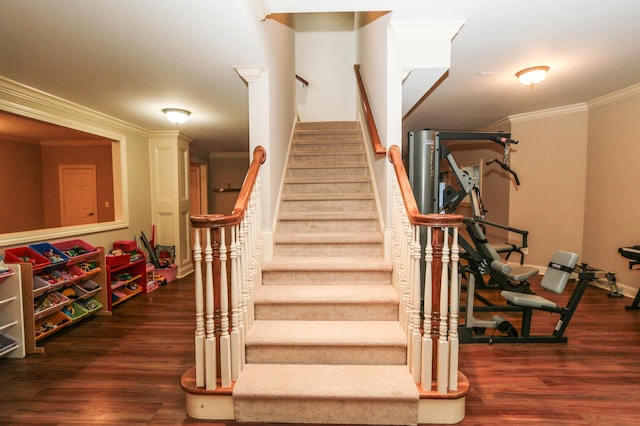 stairway with hardwood / wood-style flooring and crown molding