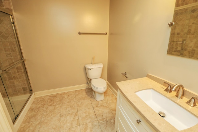 bathroom with toilet, an enclosed shower, and vanity