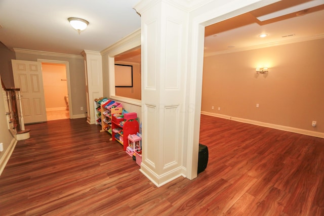 hall with dark wood-type flooring and ornamental molding