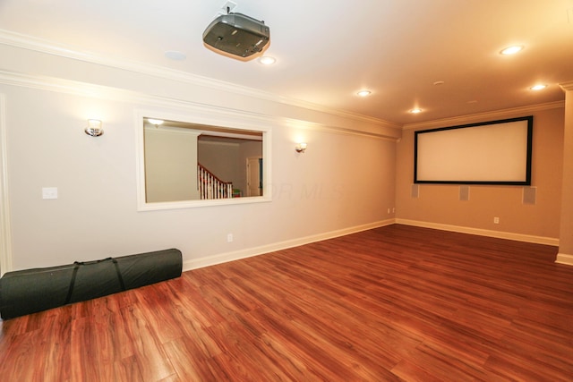 cinema room featuring crown molding and wood-type flooring