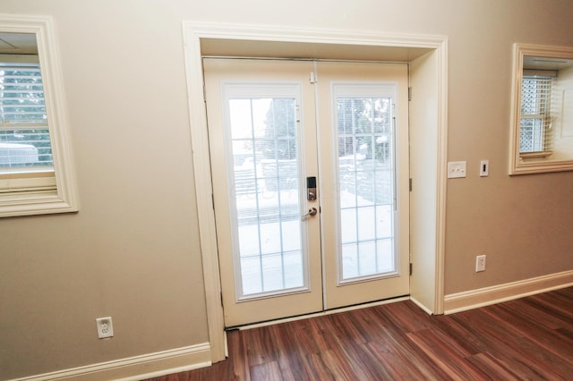 entryway with dark hardwood / wood-style flooring and french doors