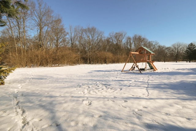 yard layered in snow with a playground