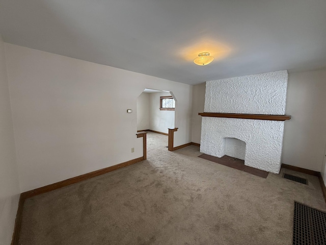 unfurnished living room featuring light carpet