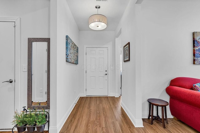 hallway with light hardwood / wood-style flooring