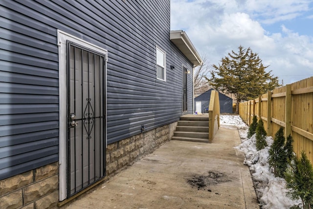 view of property exterior with a storage unit