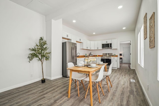 dining space featuring hardwood / wood-style flooring