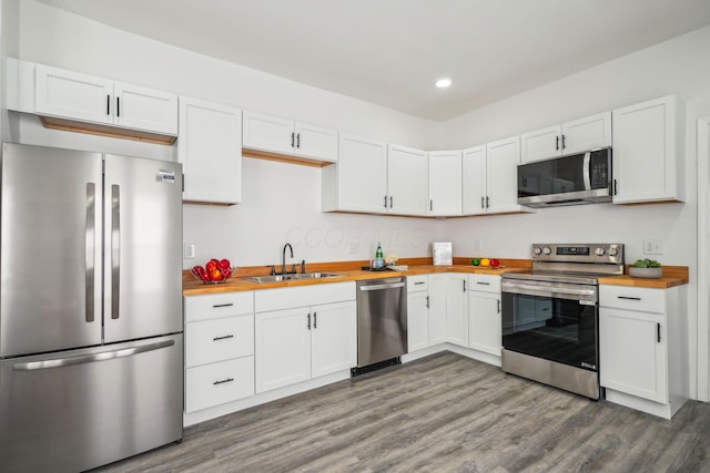 kitchen featuring sink, white cabinets, appliances with stainless steel finishes, and wooden counters