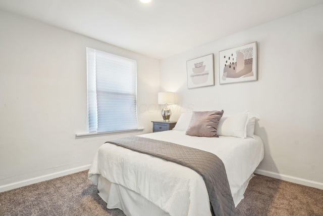 bedroom with dark colored carpet