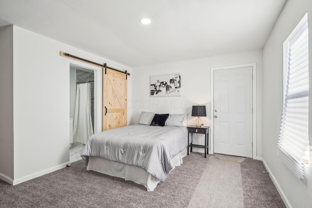 bedroom with carpet floors and a barn door