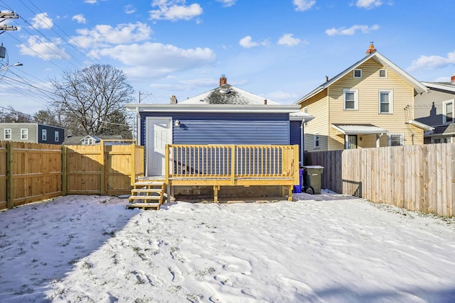 snow covered house with a deck