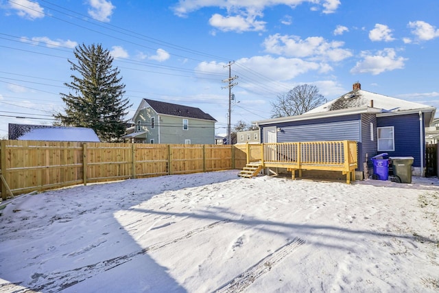 yard covered in snow featuring a wooden deck