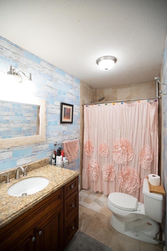 bathroom featuring toilet, vanity, walk in shower, and a textured ceiling