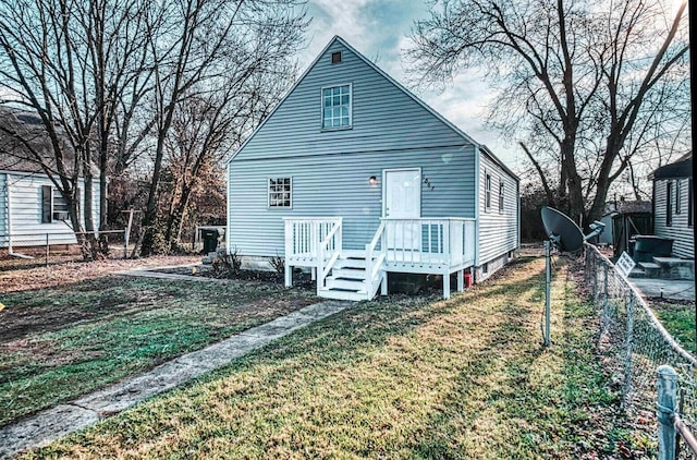 rear view of house with a yard