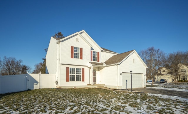 snow covered property with a garage