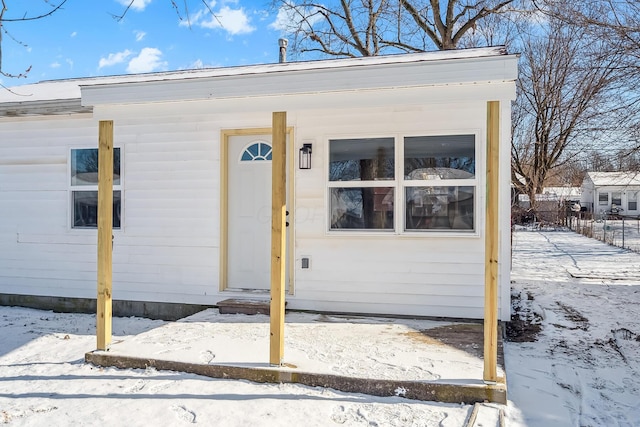 view of snow covered property entrance