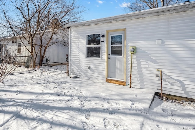 view of snow covered property entrance