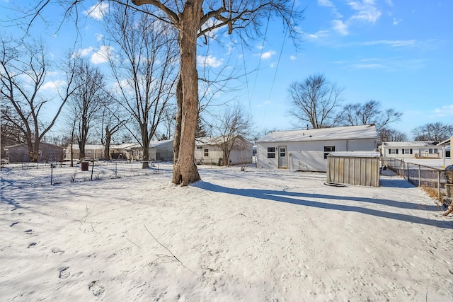 view of snow covered rear of property