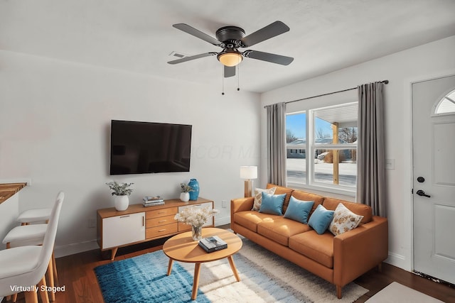 living room with dark wood-type flooring and ceiling fan