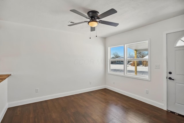 entrance foyer featuring ceiling fan, dark hardwood / wood-style flooring, and a healthy amount of sunlight