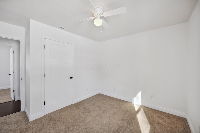 unfurnished bedroom with ceiling fan, carpet flooring, and a closet