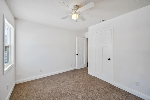 empty room with carpet floors and ceiling fan