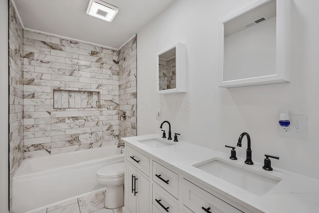 full bathroom featuring tiled shower / bath combo, vanity, and toilet