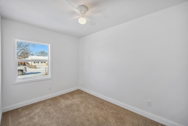 carpeted empty room featuring ceiling fan