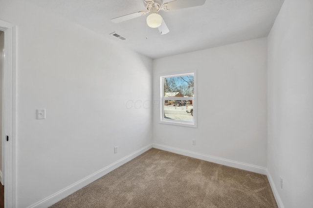 carpeted spare room with ceiling fan