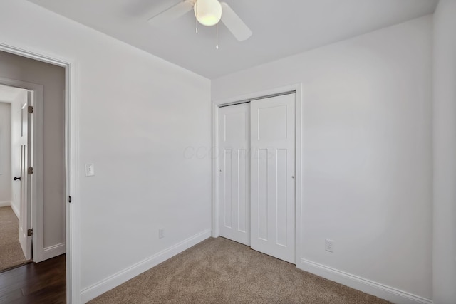 unfurnished bedroom featuring ceiling fan, a closet, and dark colored carpet