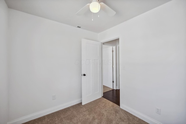 spare room featuring ceiling fan and carpet floors