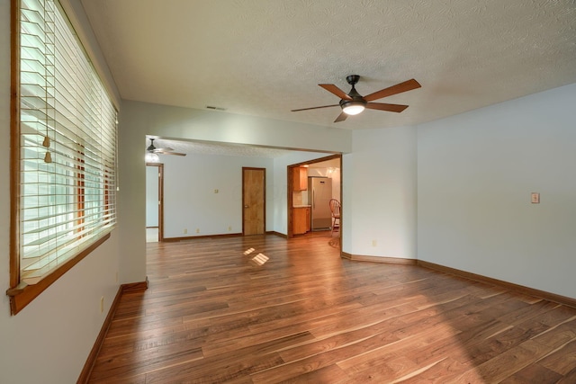 empty room featuring hardwood / wood-style floors, a textured ceiling, and ceiling fan