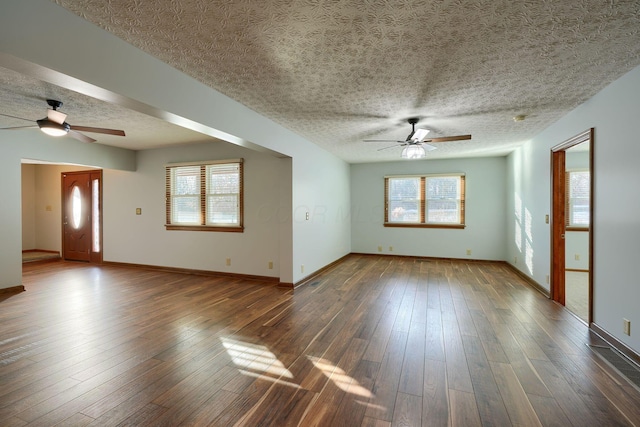 unfurnished room featuring ceiling fan, a textured ceiling, and dark hardwood / wood-style flooring