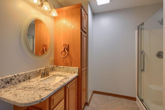 bathroom featuring vanity and a shower with door