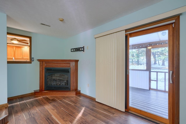 unfurnished living room featuring dark hardwood / wood-style floors