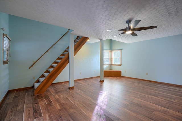 additional living space with ceiling fan, dark hardwood / wood-style floors, a textured ceiling, and lofted ceiling