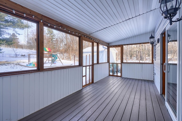 unfurnished sunroom featuring vaulted ceiling