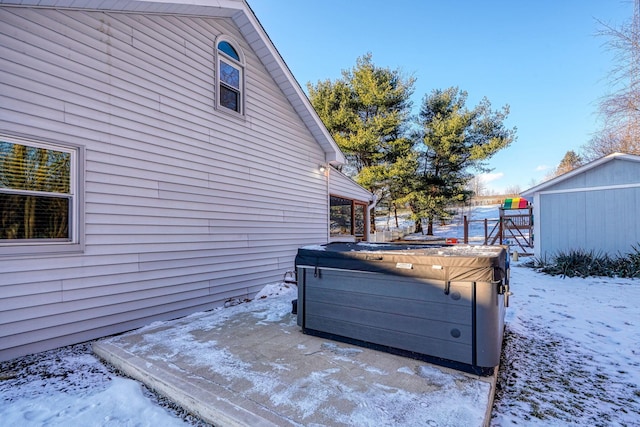 exterior space featuring a hot tub and a storage unit