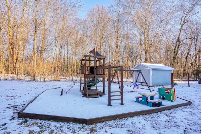 snow covered playground featuring a storage unit