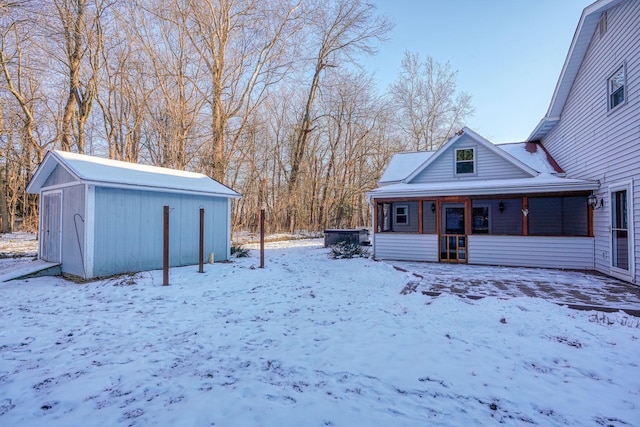 snowy yard featuring covered porch