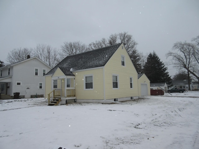 view of snow covered rear of property